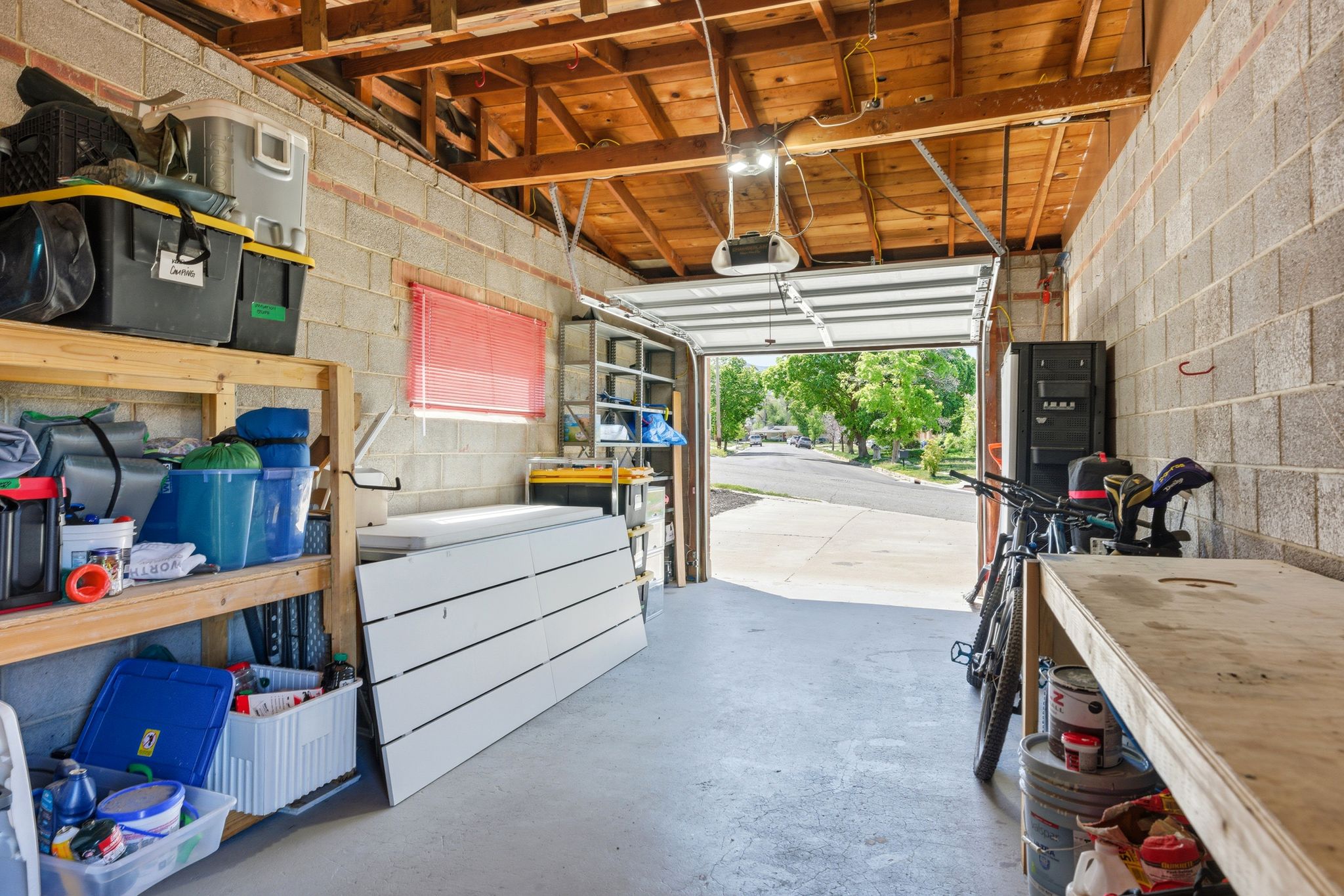 Garage with concrete block wall and a garage door opener