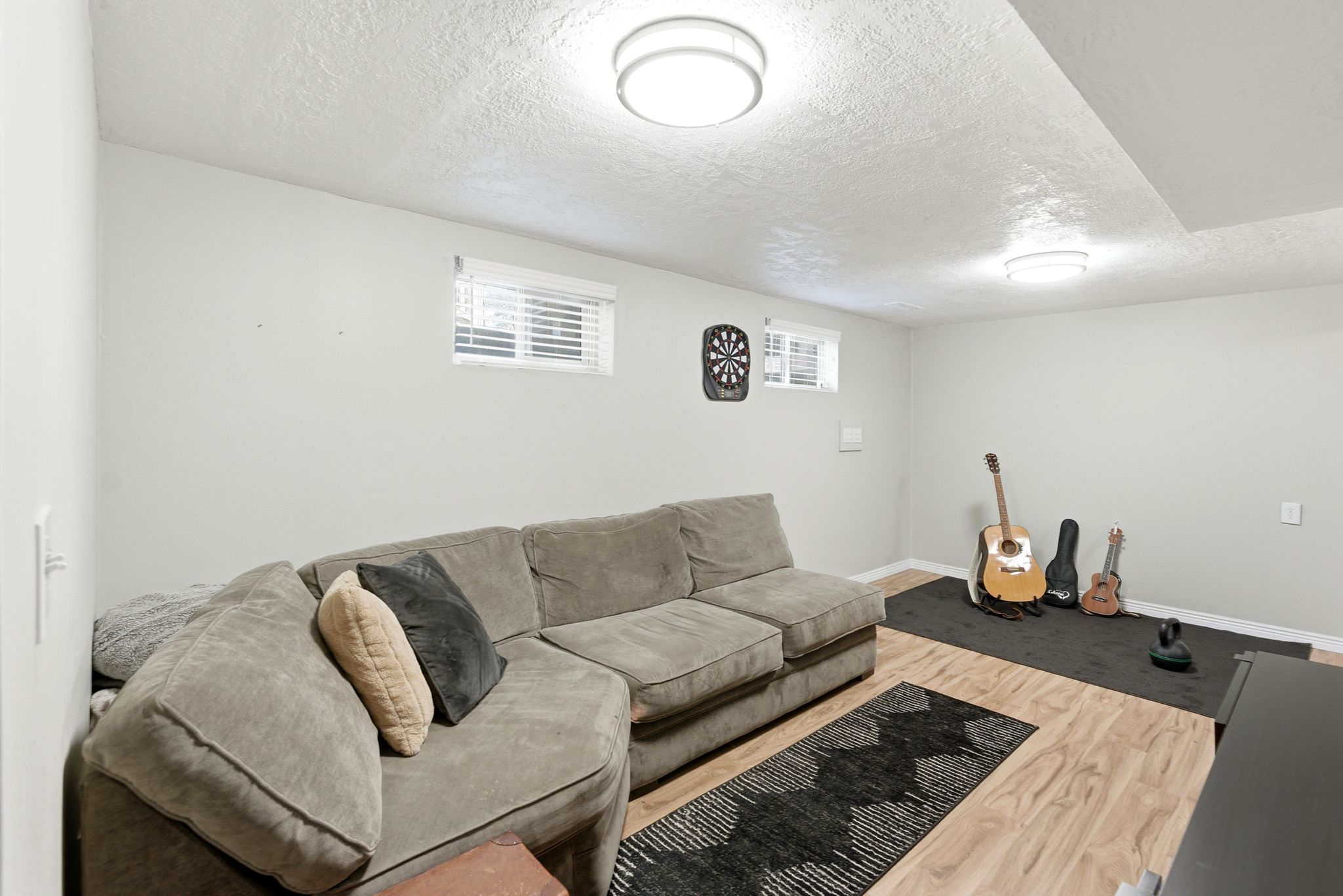 Living area featuring a textured ceiling and light wood finished floors