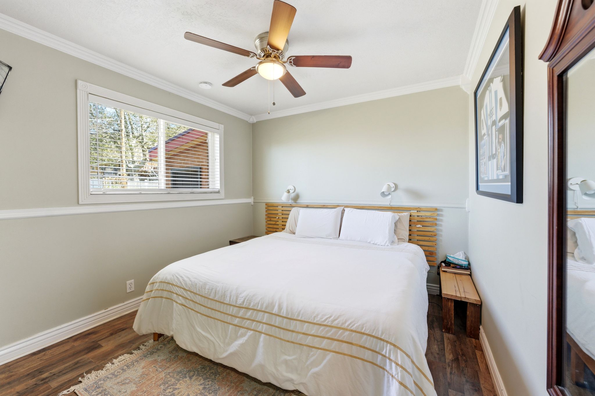 Bedroom featuring crown molding, dark wood-type flooring, and a ceiling fan