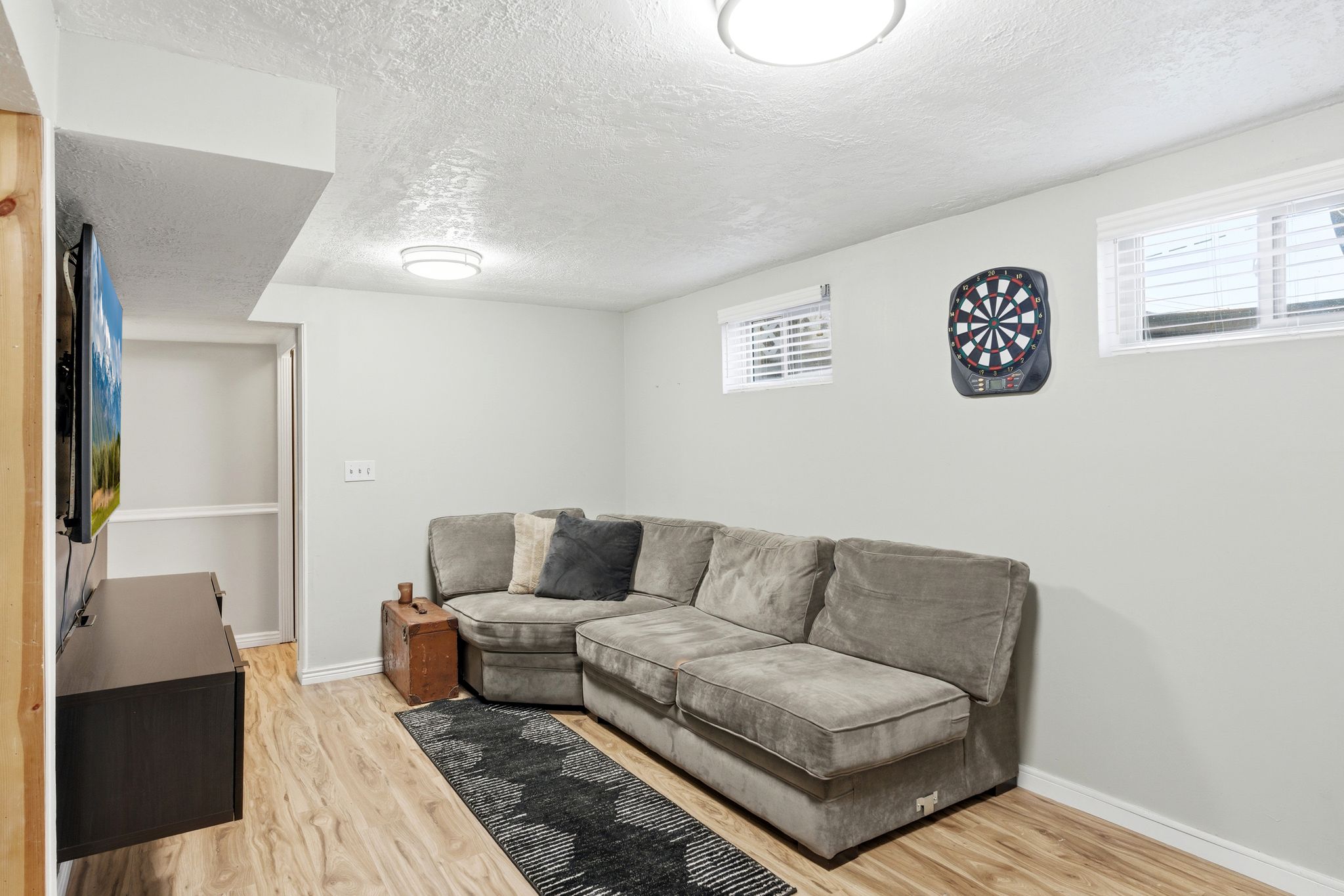 Living room featuring light wood-style flooring and a textured ceiling