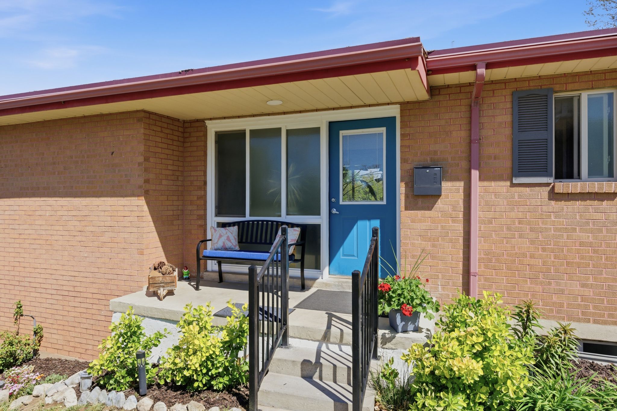 View of exterior entry featuring brick siding and a porch