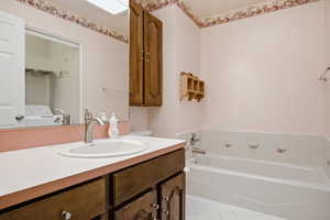 Bathroom featuring vanity and a bath