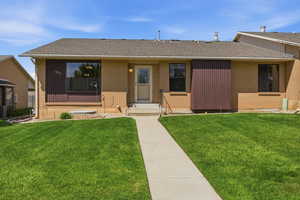 Single story home featuring a front lawn, a shingled roof, and brick siding