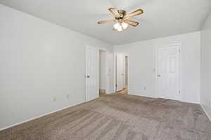 Unfurnished bedroom featuring light colored carpet and ceiling fan