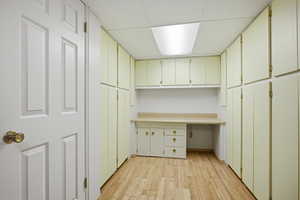 Unfurnished office with light wood-style flooring and a drop ceiling