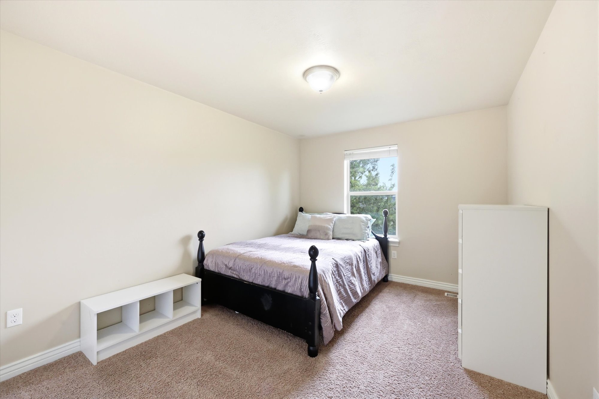 Carpeted bedroom featuring baseboards