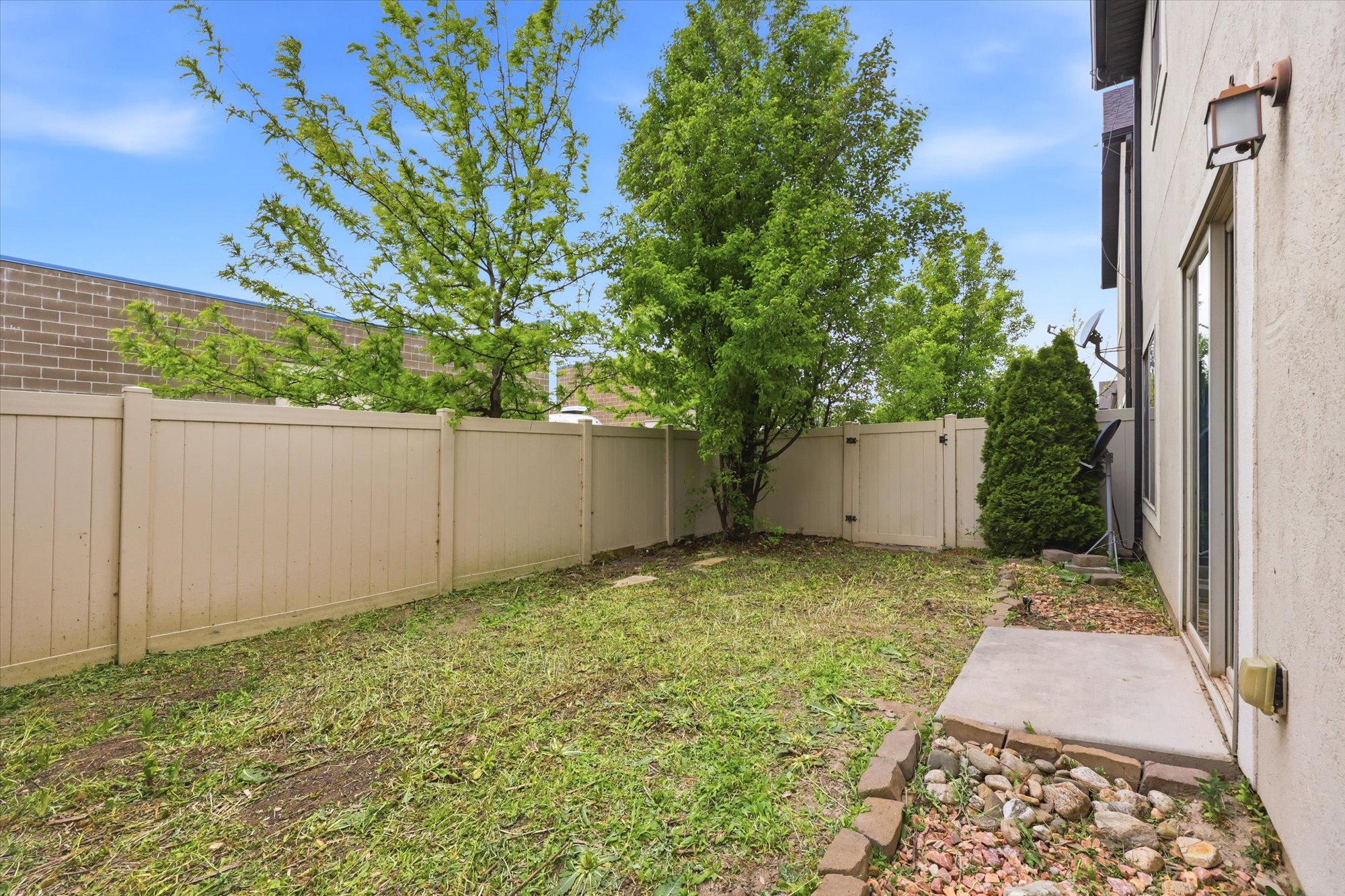 Fenced backyard featuring a gate