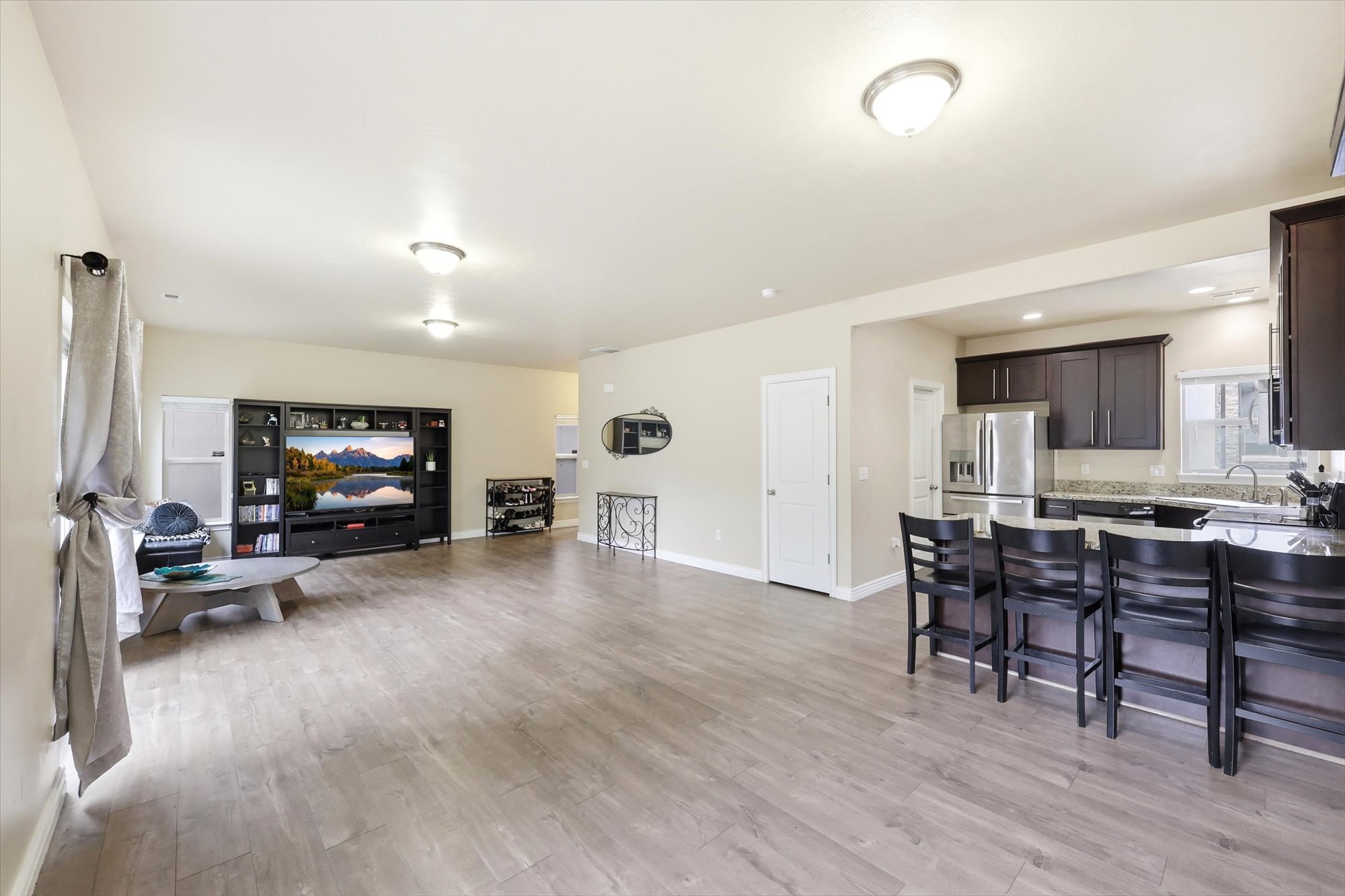 Living Room and Kitchen area featuring light wood finished floors and baseboards