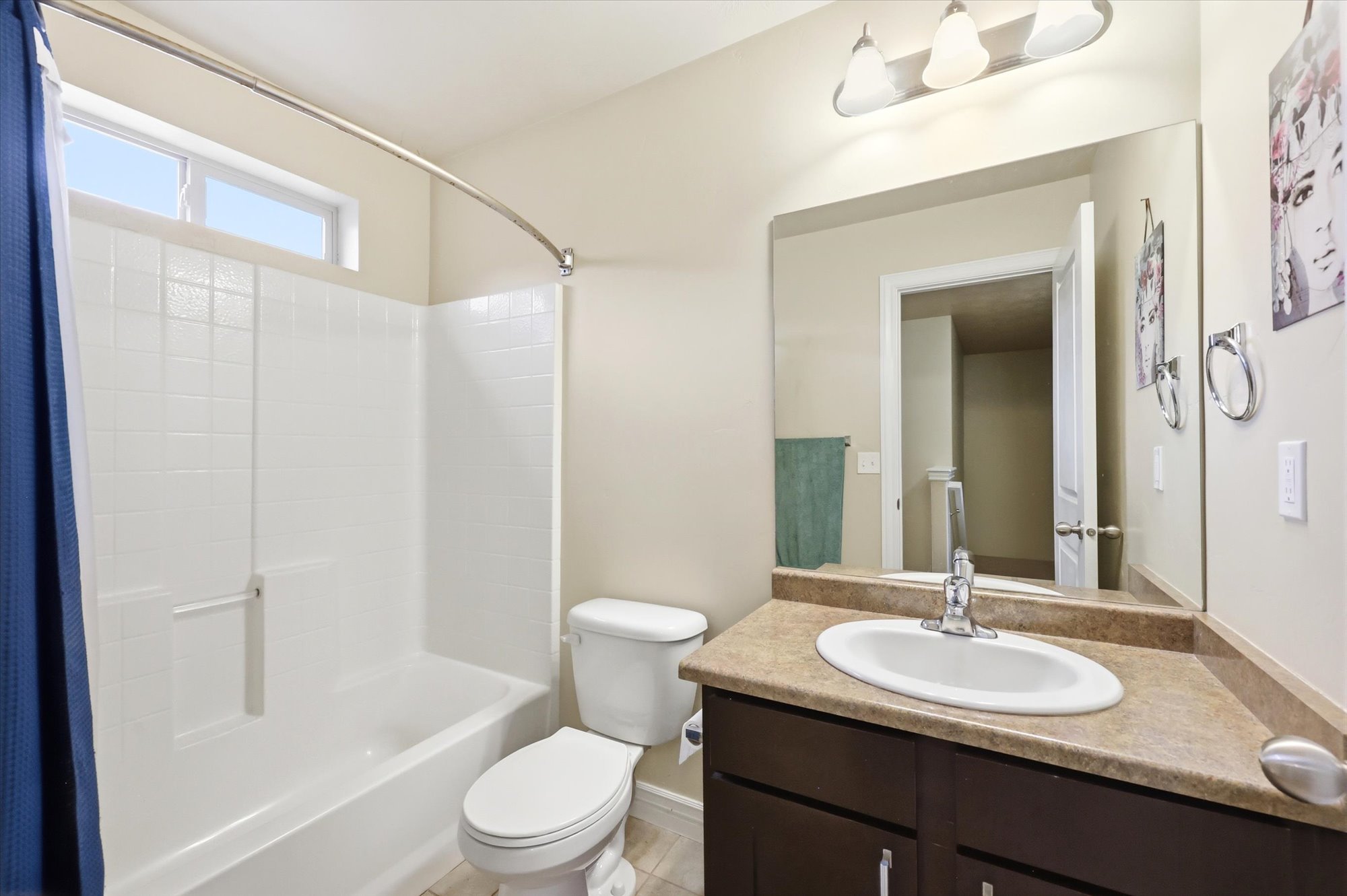 Bathroom featuring vanity and shower / bathtub combination with curtain
