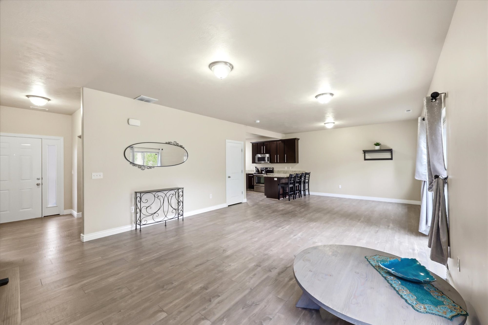 Unfurnished living room featuring light wood-style floors and baseboards
