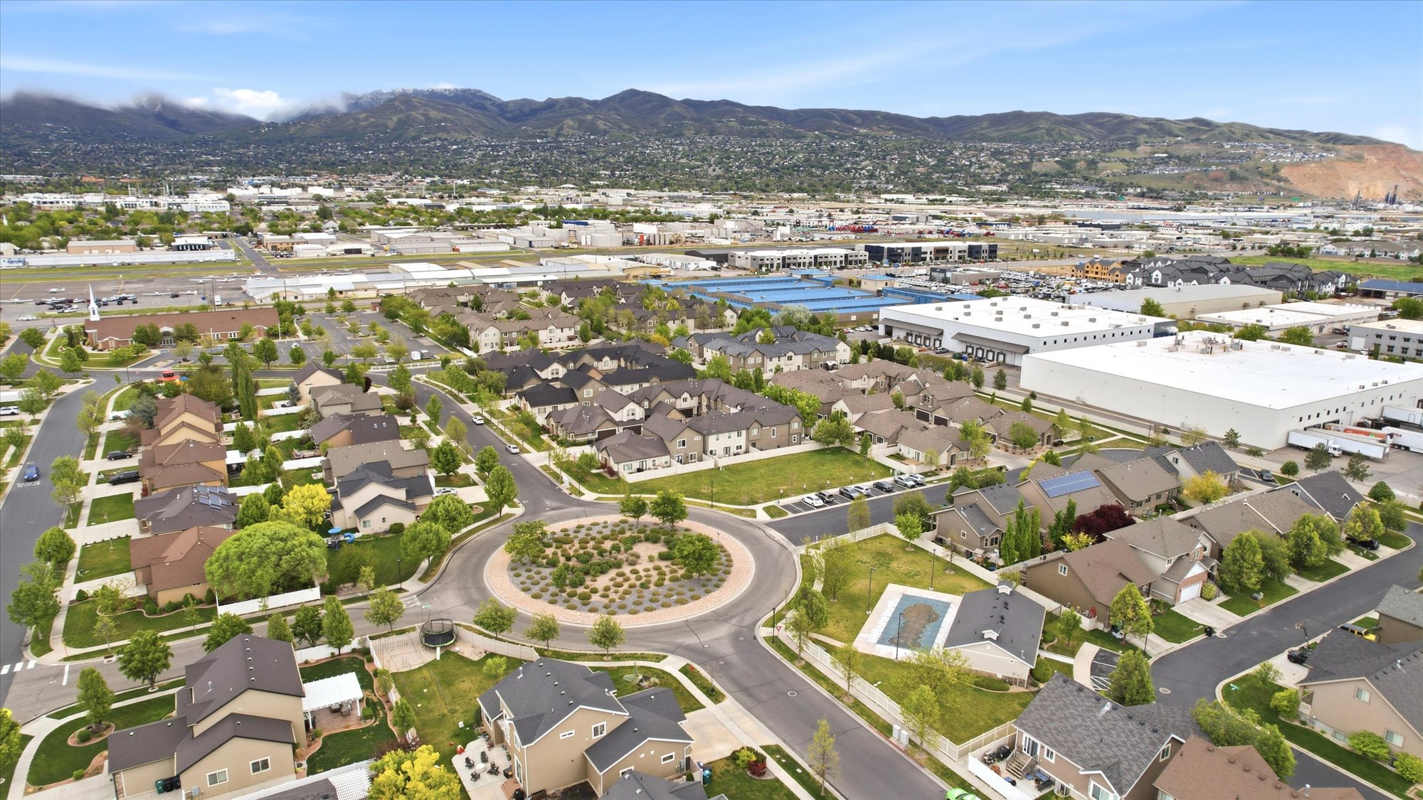 Aerial view of property's location featuring mountains and nearby suburban area