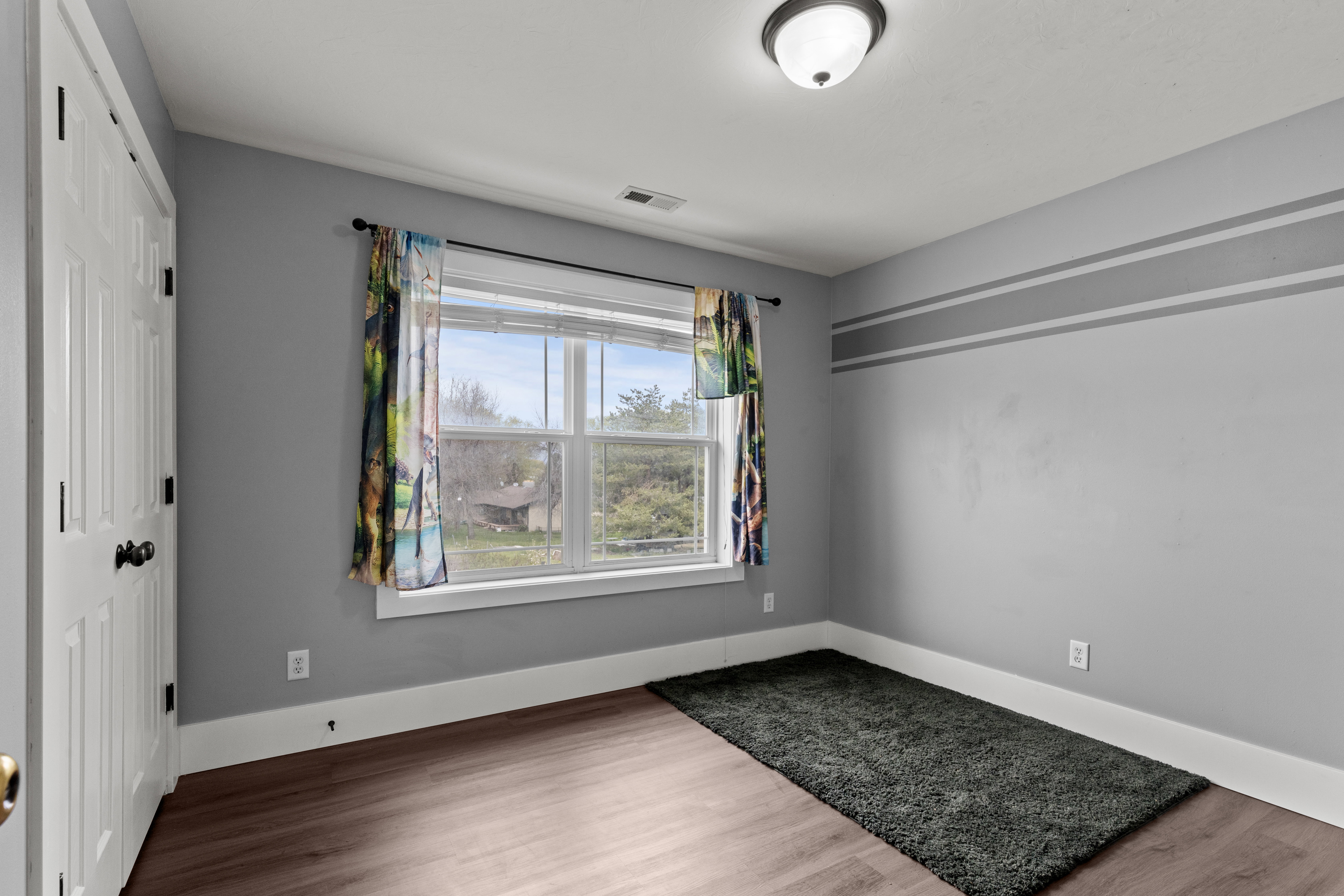 Empty room with wood finished floors and baseboards