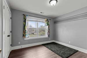 Empty room with wood finished floors and baseboards