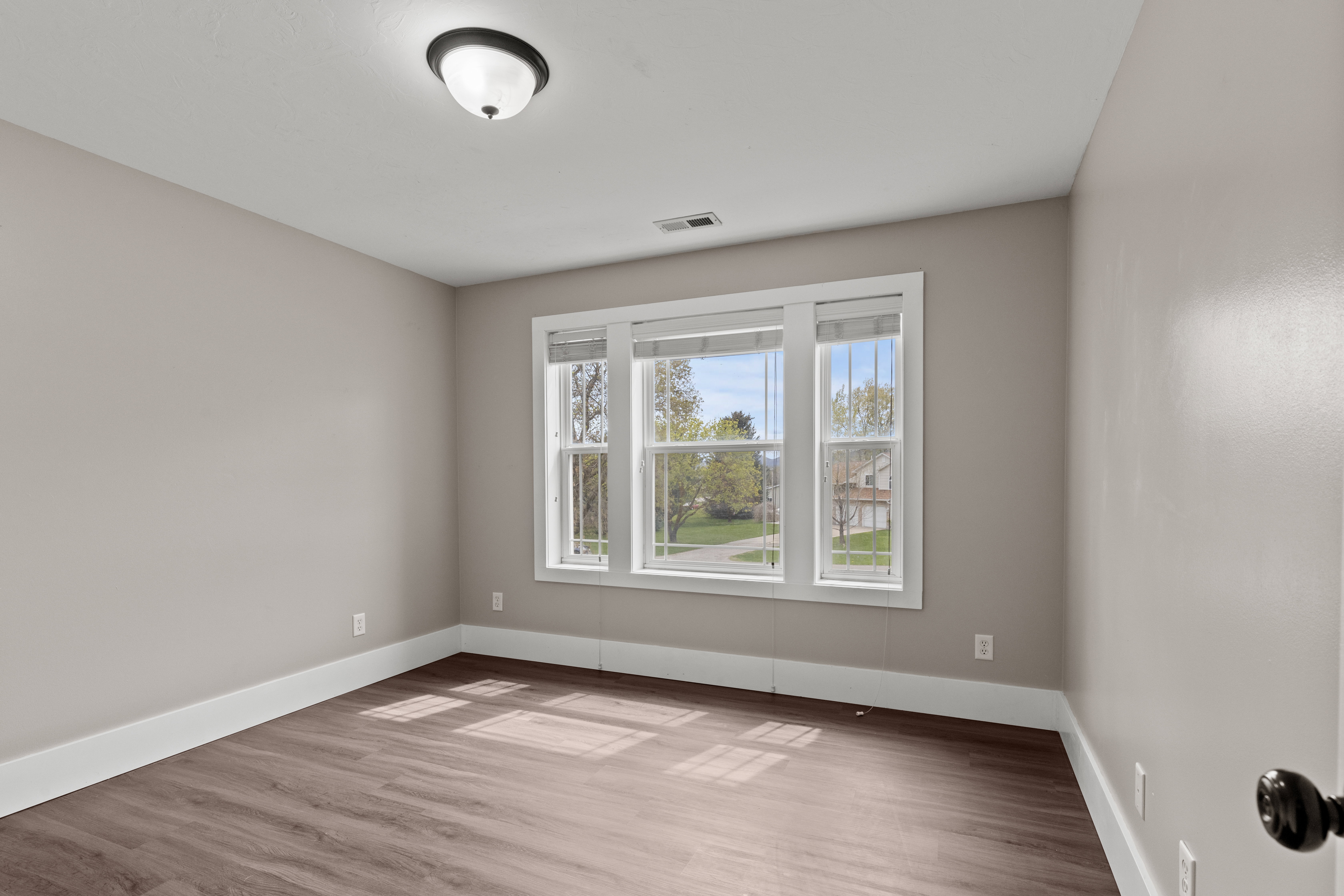 Empty room with light wood-style floors