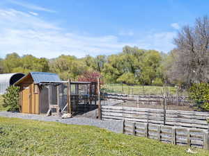 View of yard with exterior structure and an outbuilding