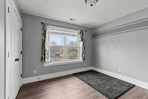 Empty room featuring wood finished floors and baseboards