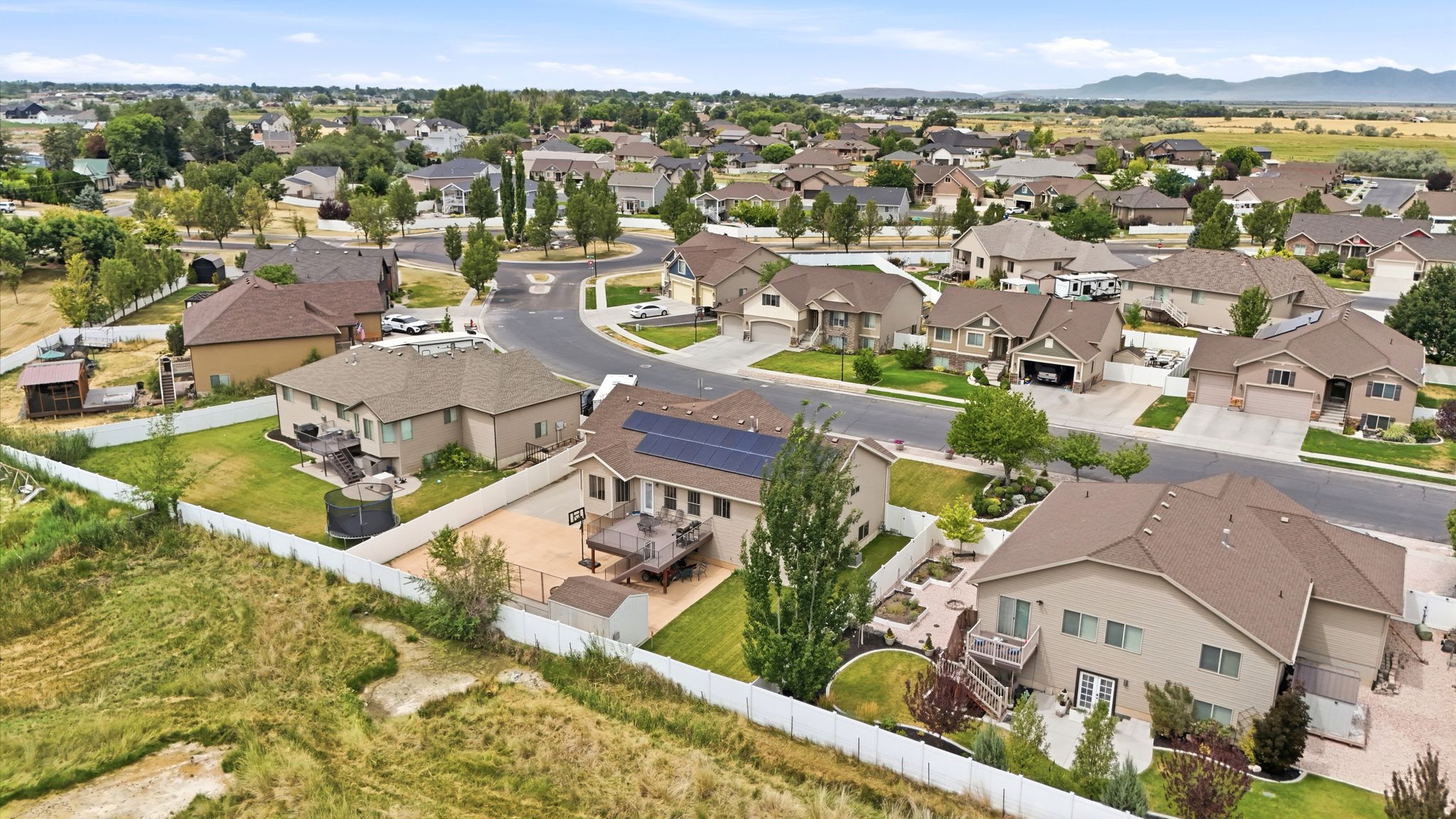 Aerial perspective of a residential neighborhood featuring several homes with mature landscaping