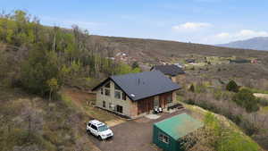 Aerial view of property and surrounding area with a mountain backdrop