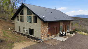 Rear view of property featuring a metal roof and a mountain view