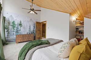 Bedroom with carpet flooring, ceiling fan, and a vaulted wooden ceiling
