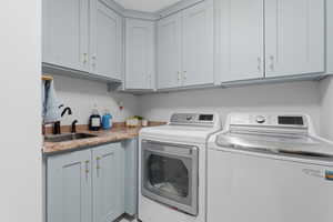 Laundry room featuring washer and dryer and cabinet space