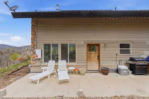 Rear view of property featuring a patio area and a mountain view