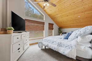 Bedroom featuring light carpet, ceiling fan, and a vaulted wooden ceiling