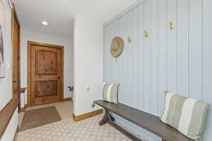 Mudroom with light floors and recessed lighting
