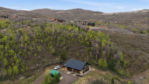 Aerial view of property and surrounding area with mountains