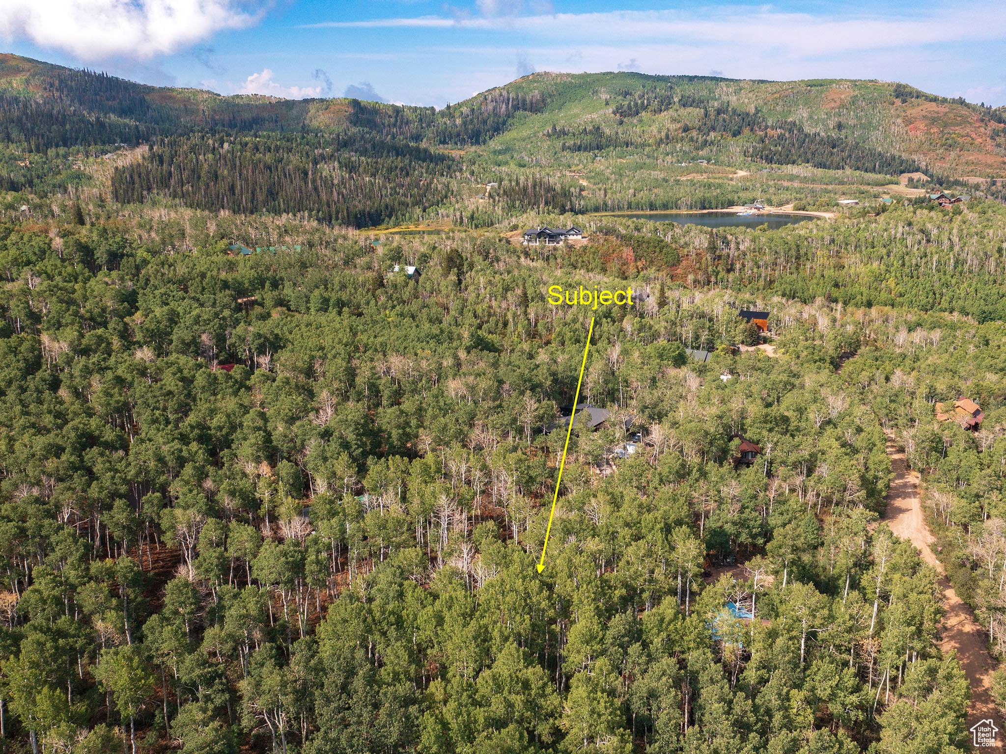 Aerial view of property's location featuring property parcel outlined and a water and mountain view
