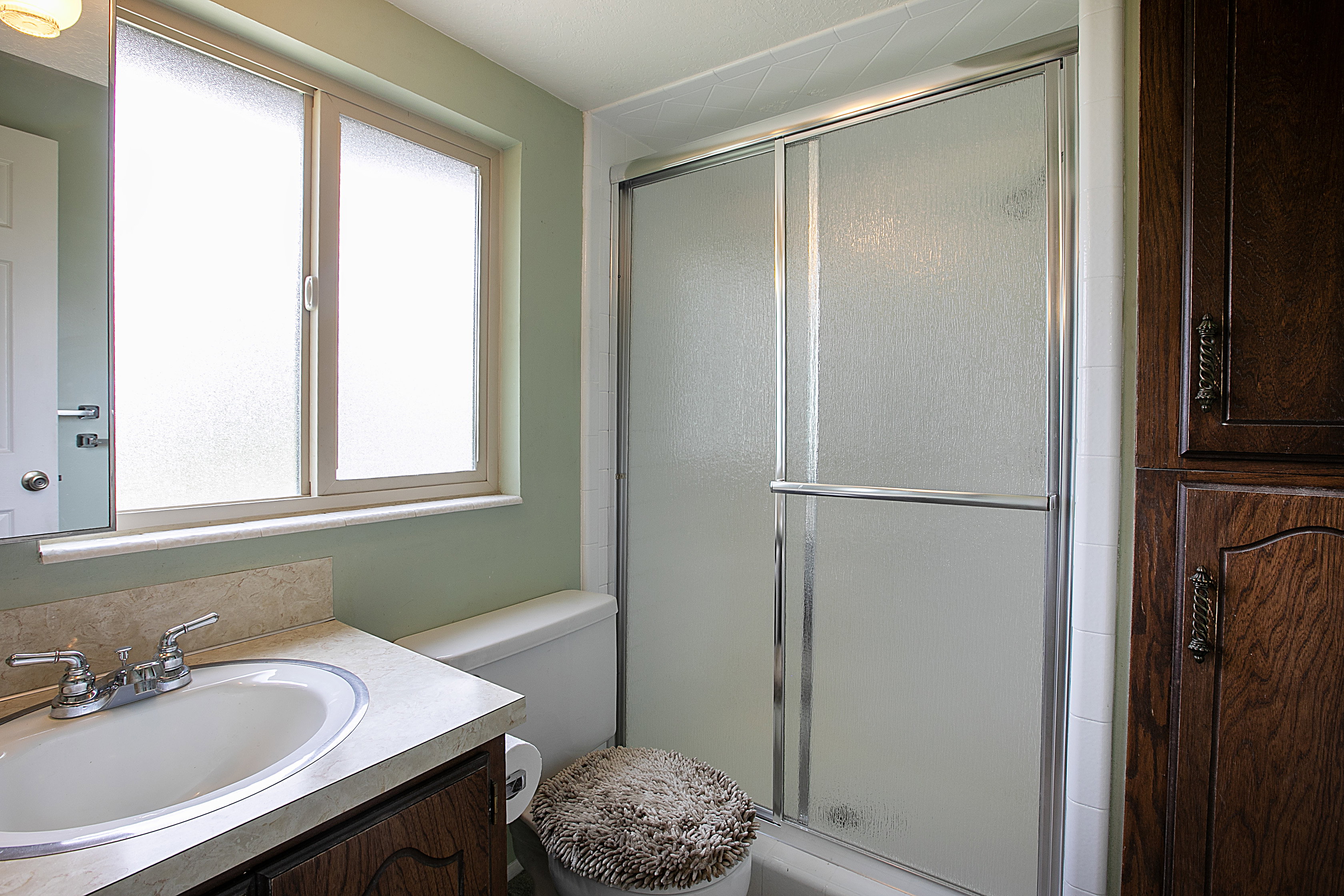 Bathroom with a shower stall and vanity