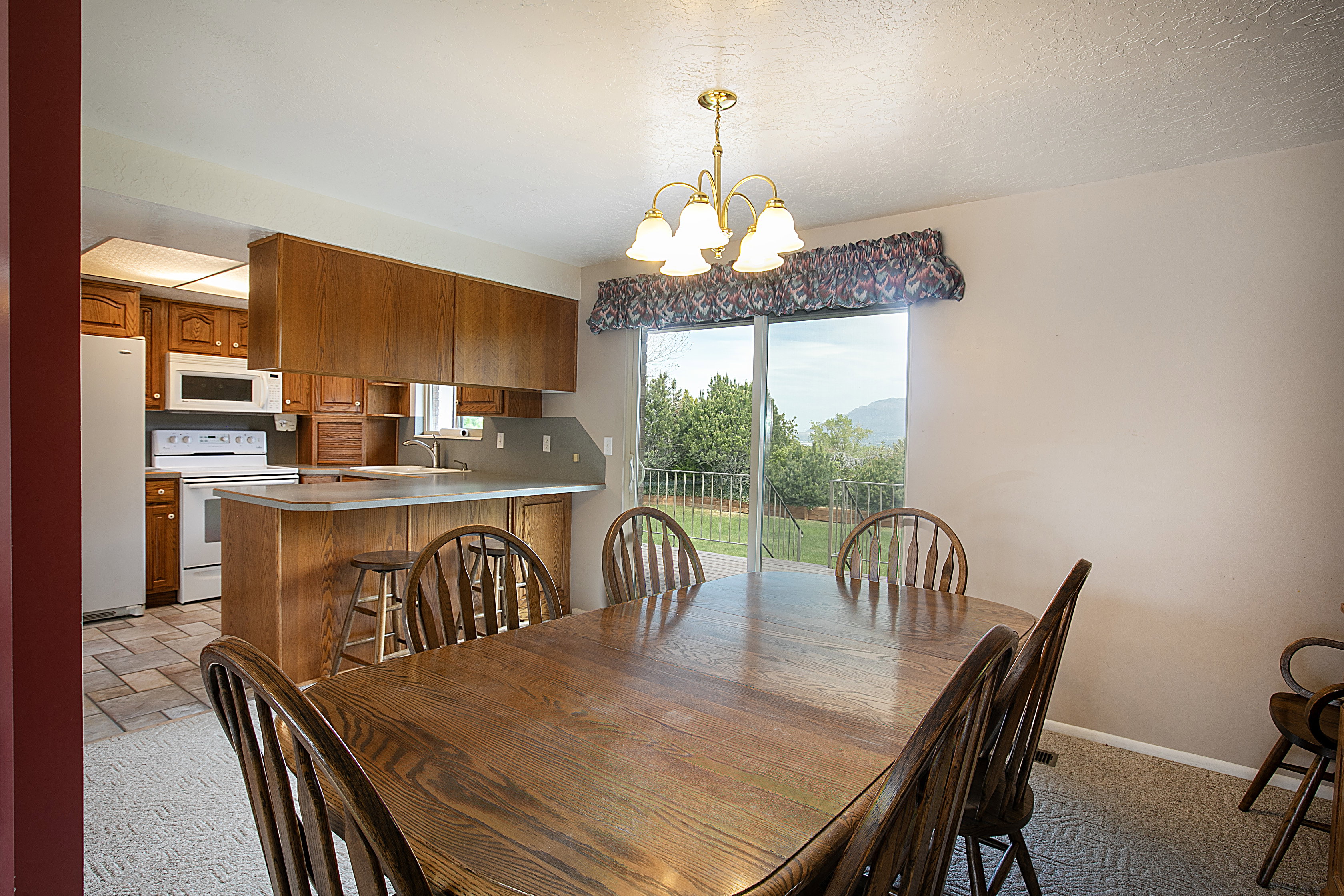 Dining room with suspended lighting and a textured ceiling