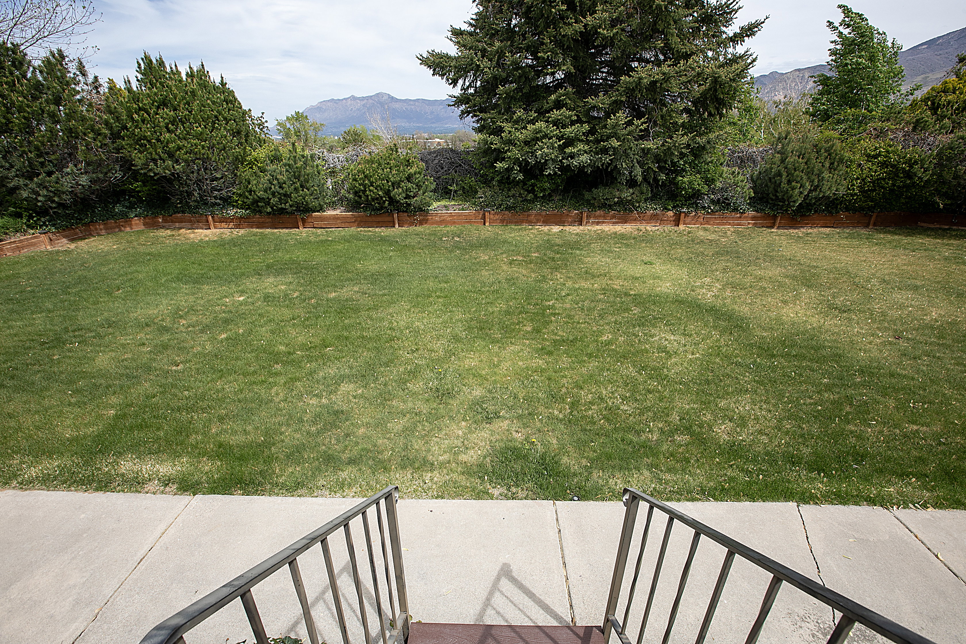 Fenced backyard featuring a mountain view