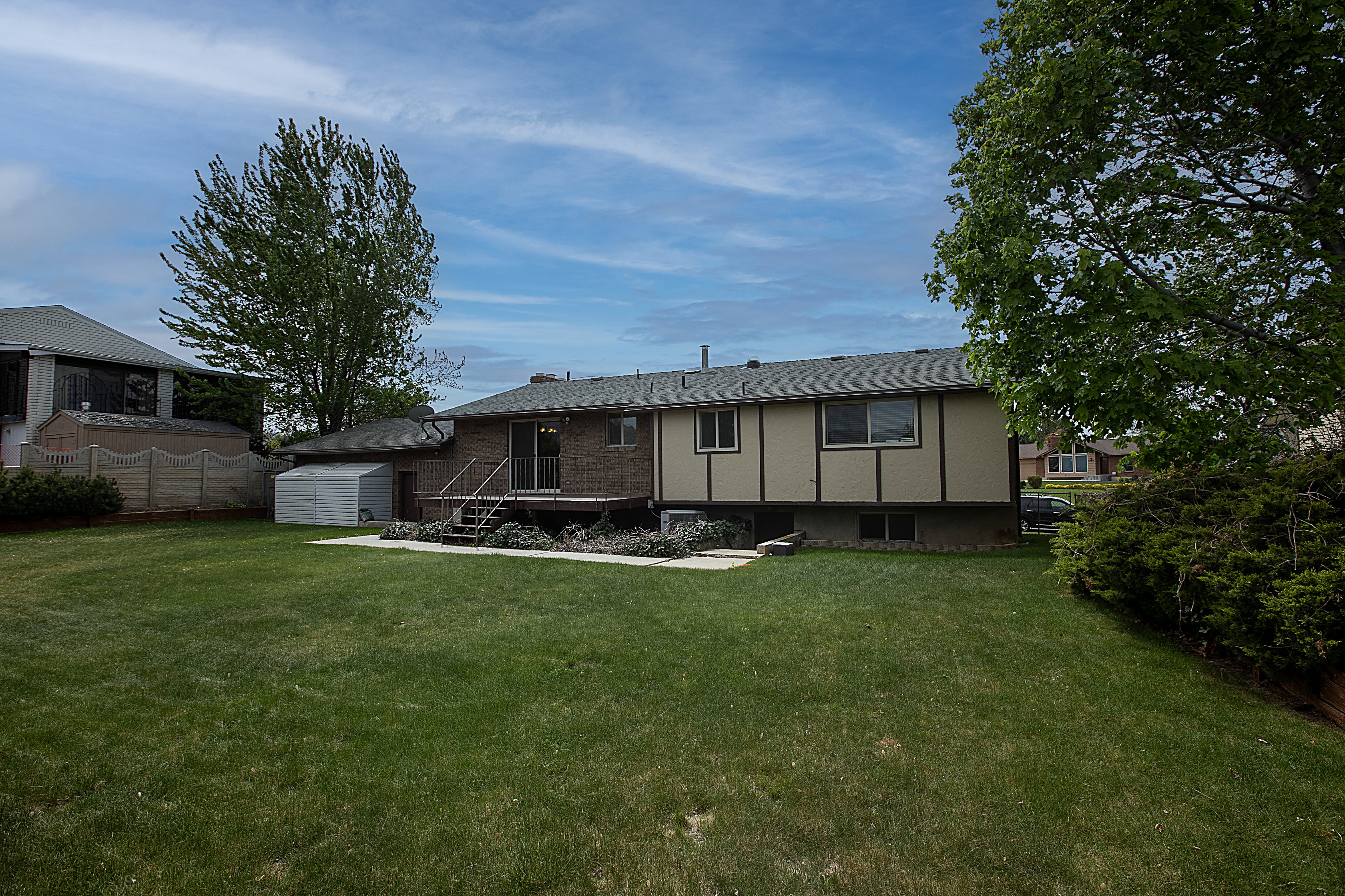 Rear view of house with a storage shed