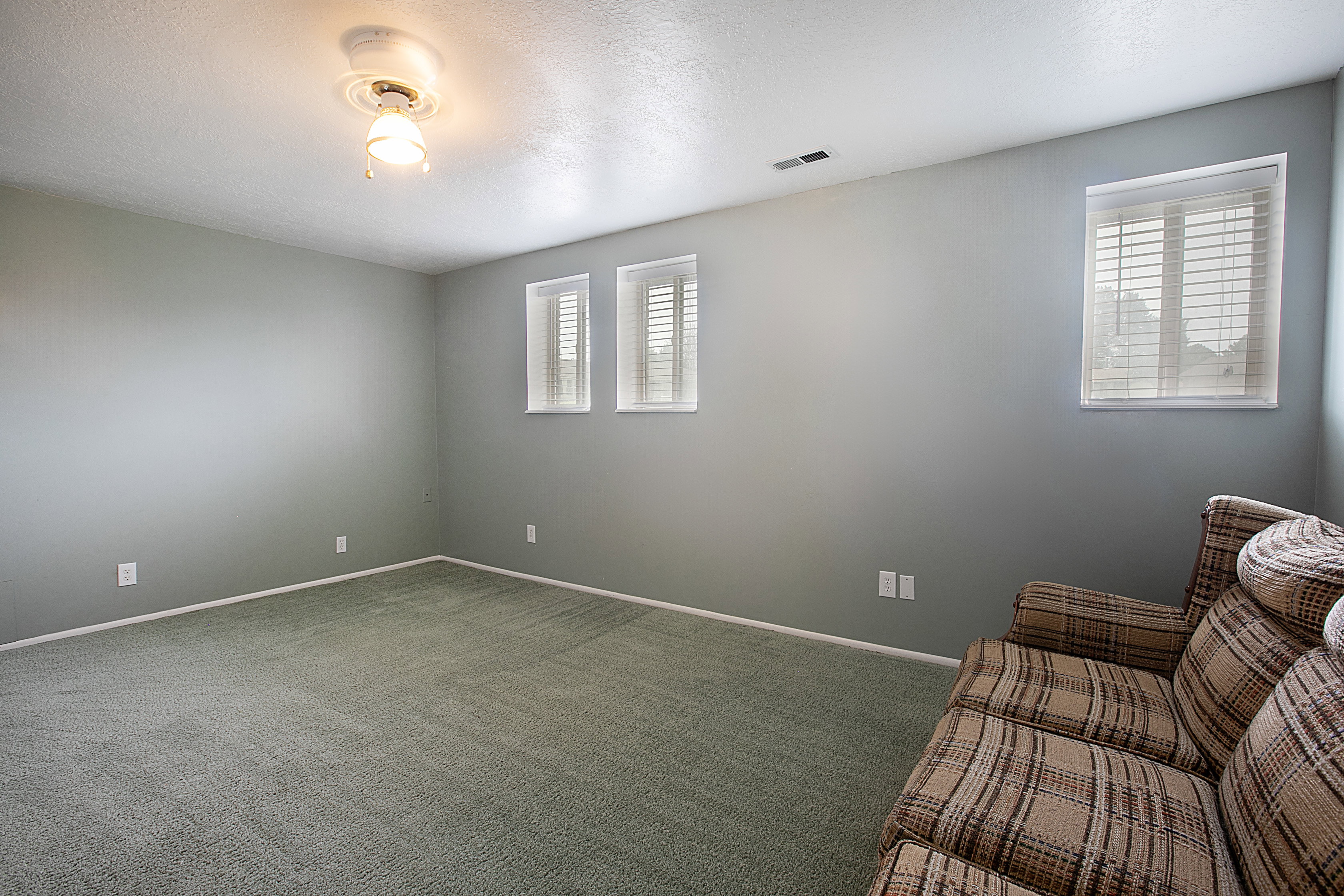 Unfurnished room with carpet floors and a textured ceiling