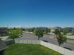 View of asphalt road featuring a residential view, sidewalks, and curbs