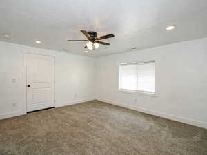 Unfurnished room with carpet flooring, ceiling fan, recessed lighting, a textured ceiling, and a smoke detector