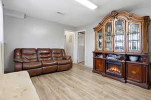 Living area featuring light wood-style flooring and baseboards