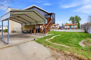 View of parking with driveway and a carport