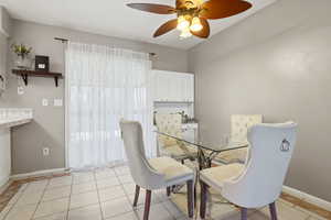 Dining area featuring ceiling fan and light tile patterned floors