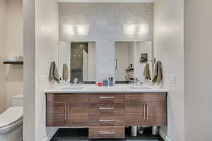 Master Bathroom featuring double vanity and a shower stall