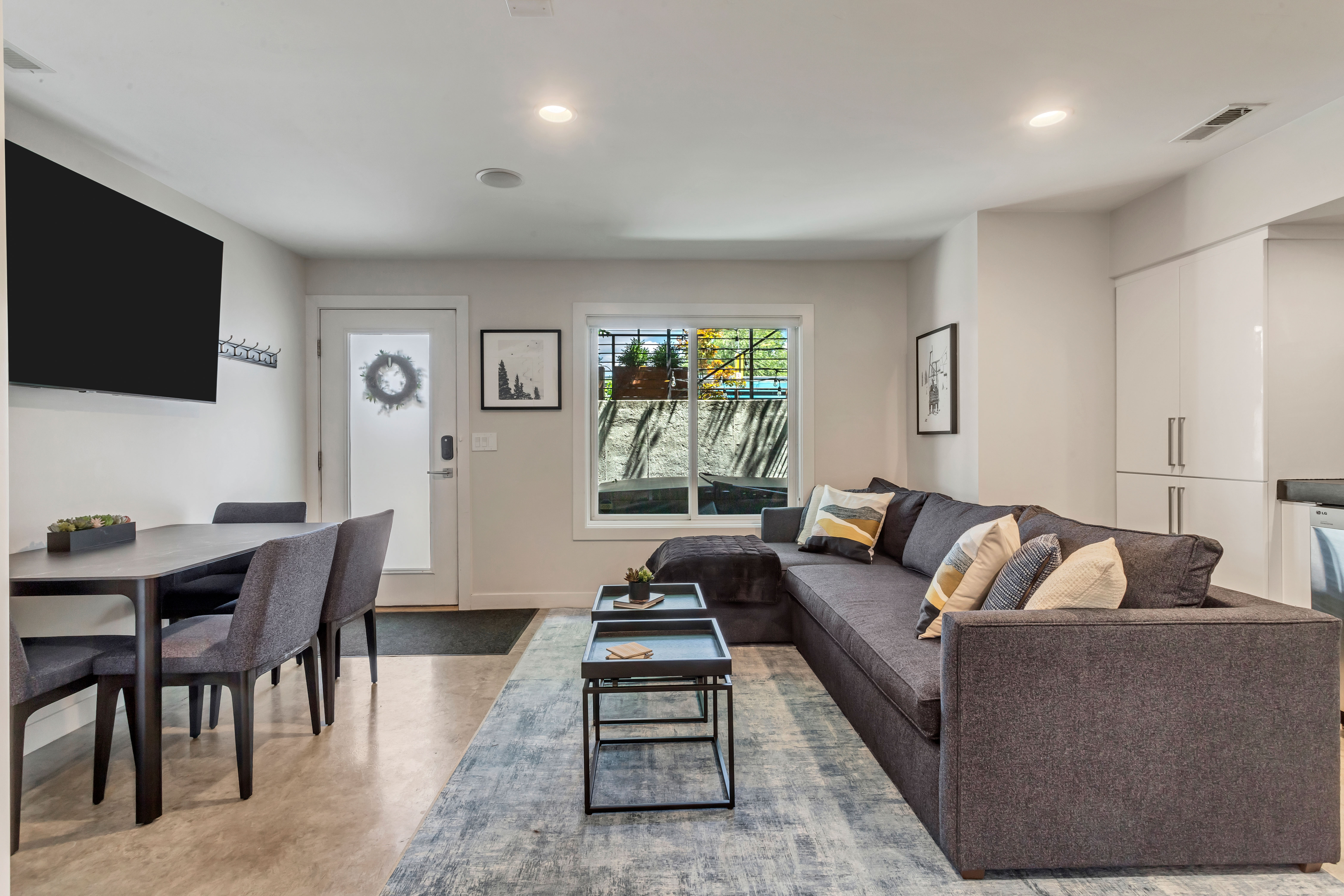 Living room featuring recessed lighting and finished concrete floors