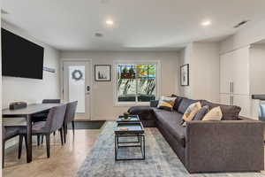 Living room featuring recessed lighting and finished concrete floors