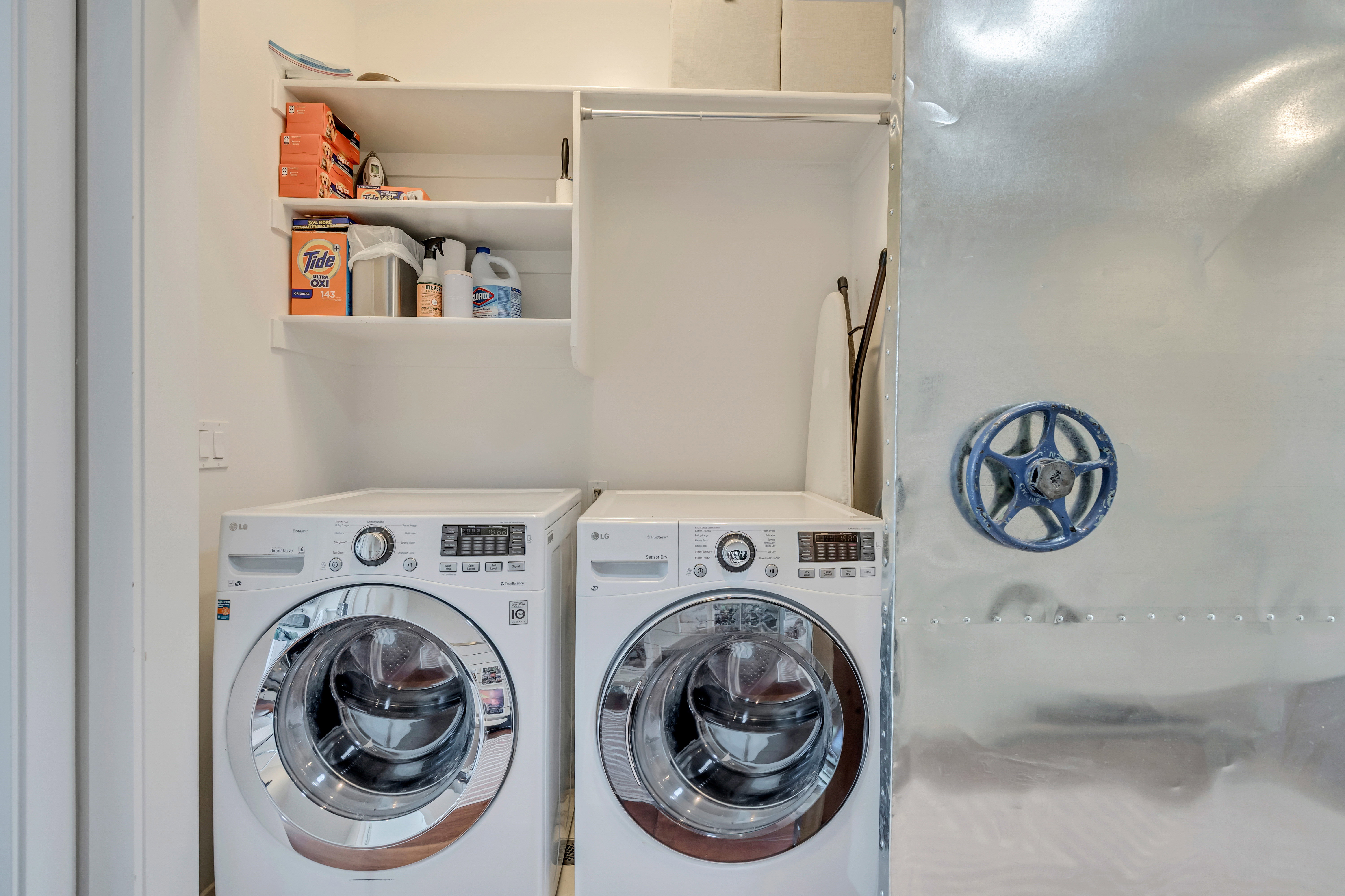 Upper level laundry area with washer and clothes dryer