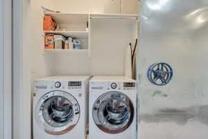 Upper level laundry area with washer and clothes dryer
