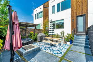 View of back yard and patio featuring a grill and a pergola