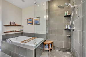 Master Full bath featuring a walk in shower, a garden tub, and tile patterned flooring