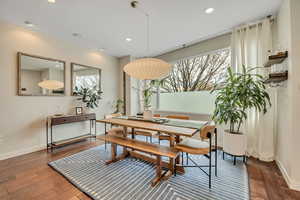 Dining area featuring dark wood-type flooring and recessed lighting