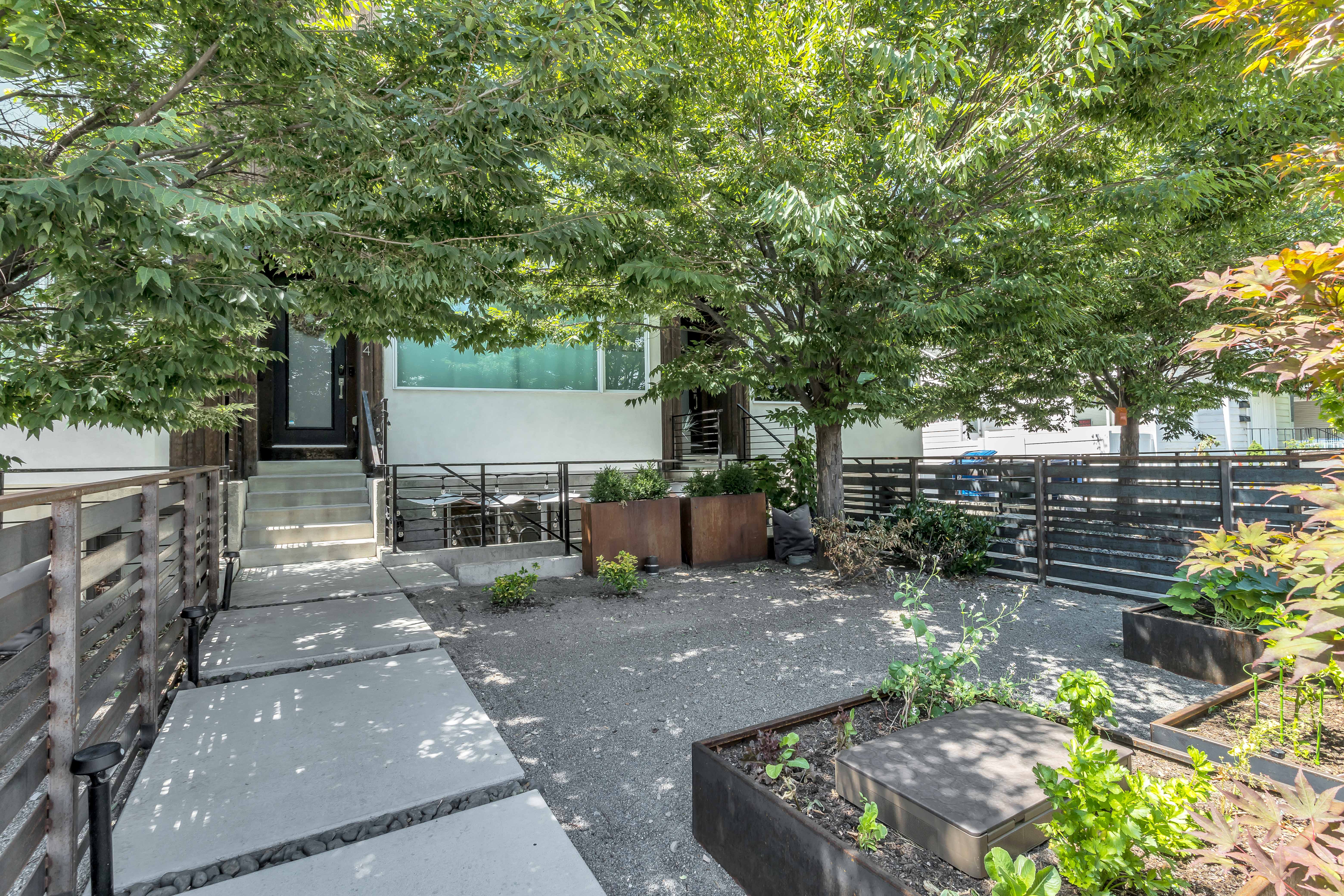 View of patio featuring a fenced front yard and a gate