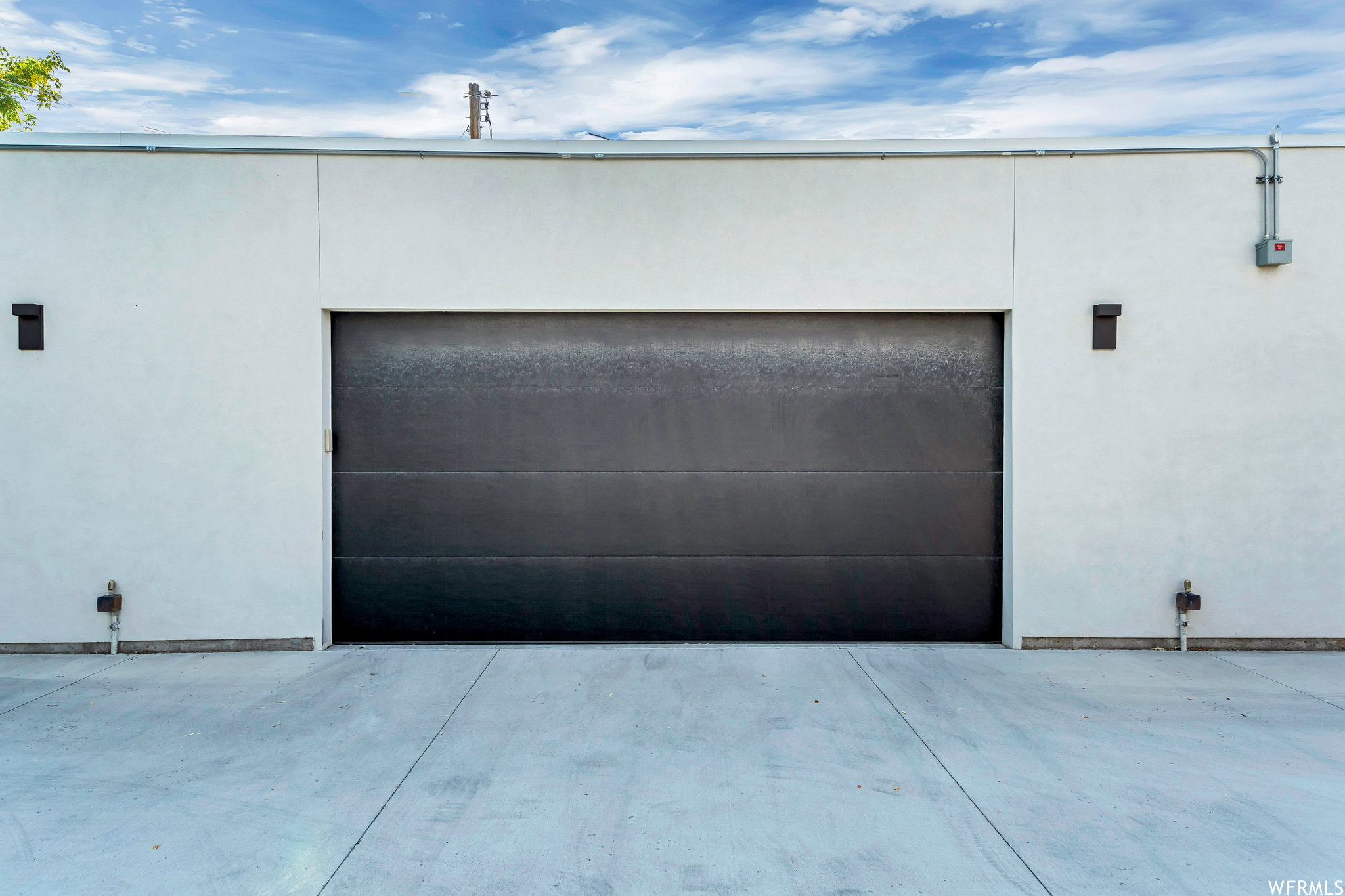 Garage featuring concrete driveway
